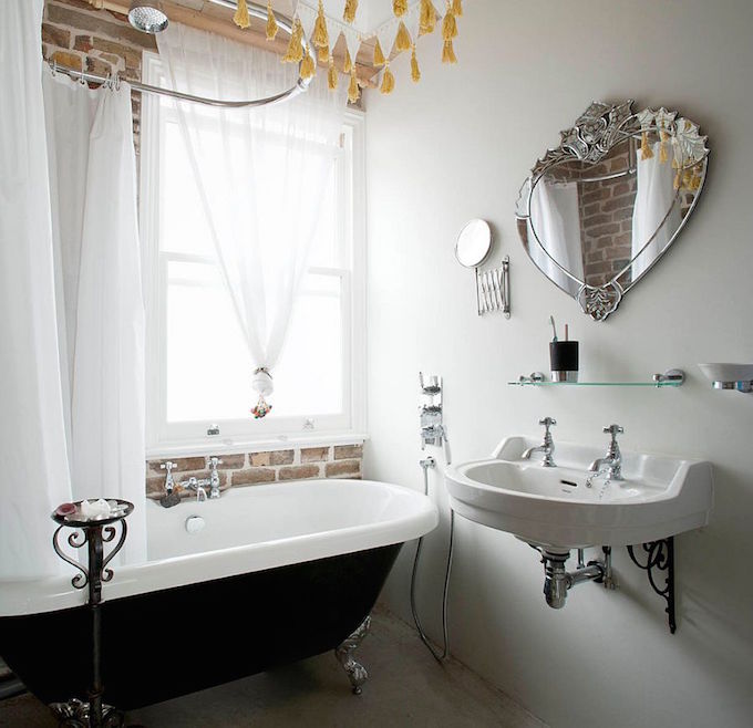 dark-indulgence-black-bathtubs-Bathroom-with-brick-wall-white-sheer-curtains-and-vintage-bathtub-in-black.jpg
