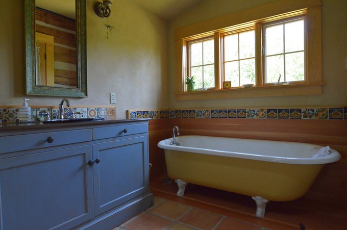 saltillo-tile-Bathroom-Rustic-with-blue-cabinets-cabin-claw-foot-bathtub-distressed-cabinets